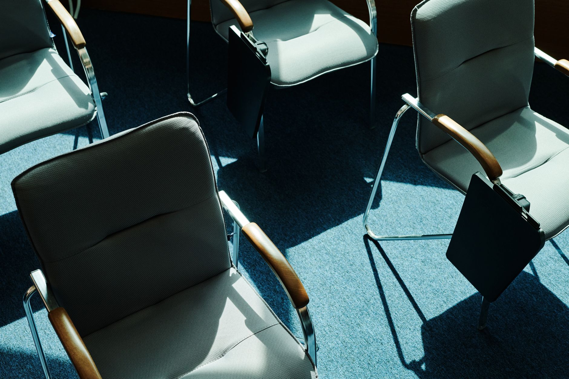 An empty, calm counselling room with two chairs, representing support services